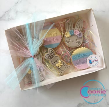 A gift box of Easter fondant cookies decorated with ribbon, a gift of easter cookies.