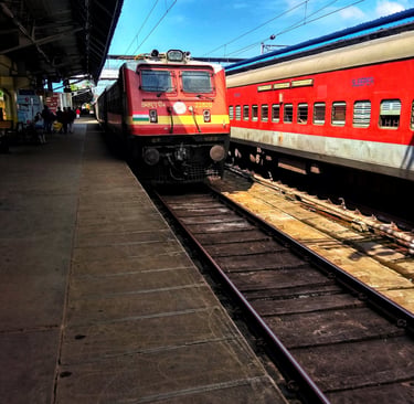 a red train is parked at a train station