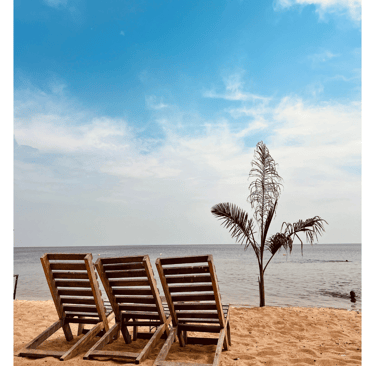 two empty chairs sitting on a Coco beach Entebbe