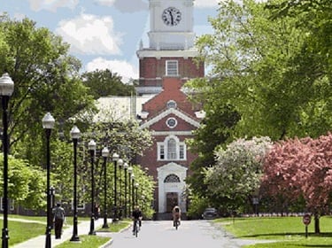 artmouth College campus with a brick building and clock tower, representing the historic & academic