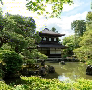 Traditional Japanese temple with pagoda roof amidst lush greenery, illustrating Japan's cultural