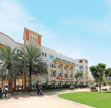 Middlesex University Dubai campus featuring a large multi-story building with a distinctive tower 