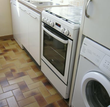 a kitchen with a washing machine and a washing machine