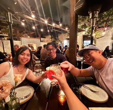 a group of people sitting at a table with drinks