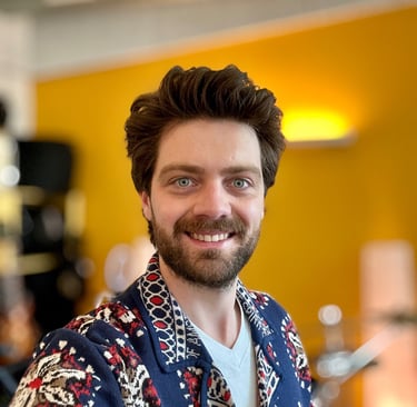 a man with a beard and a beard wearing a blue shirt
