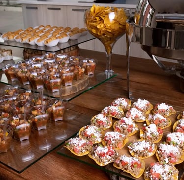 a table with a lot of food and drinks