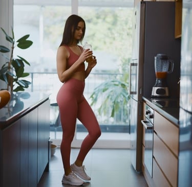 a woman in a pink jumpsuit is standing in a kitchen