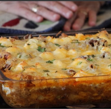 a casserole dish with cheese topping a delicious taco pie