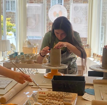 A young teenager making a slab built mug at a pottery class in Chew Magna