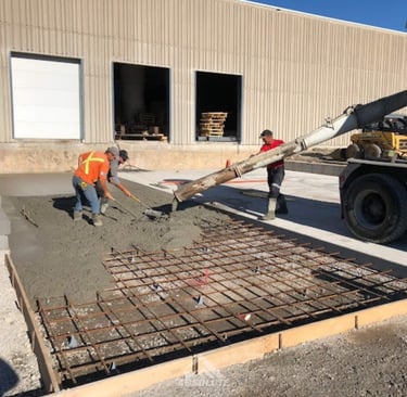 a man is pouring concrete into a concrete slab