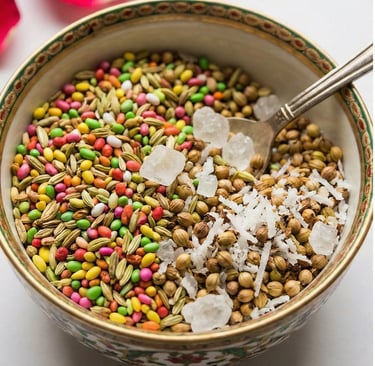 Traditional Indian mukhwas mouth freshener with fennel seeds, candy-coated seeds, and rock sugar in a decorative bowl.
