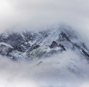 A minimalist photo of a mountain during a snow storm.