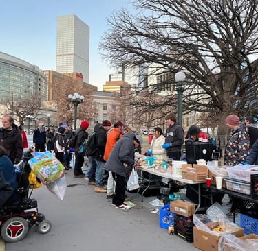 Mutual Aid Monday volunteers handing out food and supplies.
