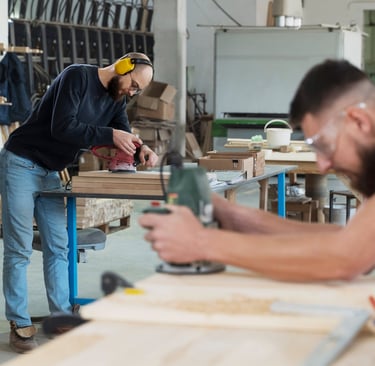 a man and woman working in a workshop