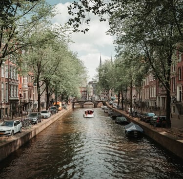 Amsterdam canals with historic buildings and reflections in water