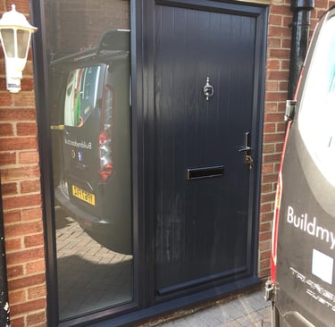 modern composite door with side panel and reflective glass. the door has chrome hardware
