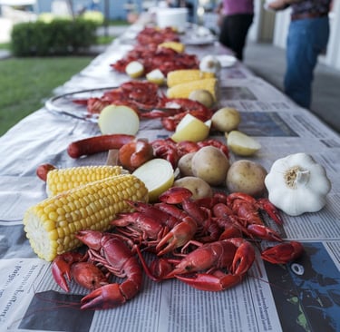 a table with a bunch of crawfish and potatoes
