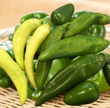 a basket of peppers on a wicker basket