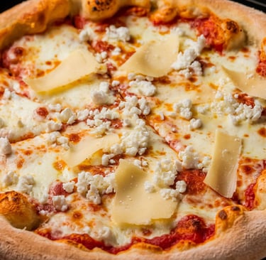 A Four Cheese Pizza with a perfectly baked crust, golden and crisp. 