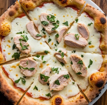 A Garlic Chicken Alfredo Pizza with a golden, crispy crust. The surface is creamy white 