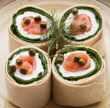 a plate of food that includes a roll - up of salmon