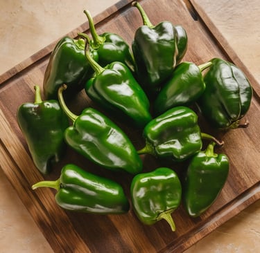 a bunch of peppers on a cutting board