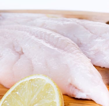 a piece of fish fillet with a slice of lemon