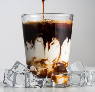a glass of coffee with ice cream and chocolate syrup