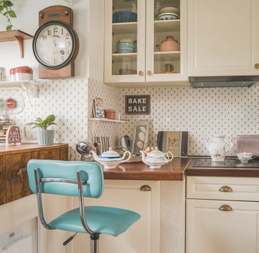 a kitchen with a blue chair and a clock