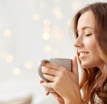 a woman is holding a cup of coffee