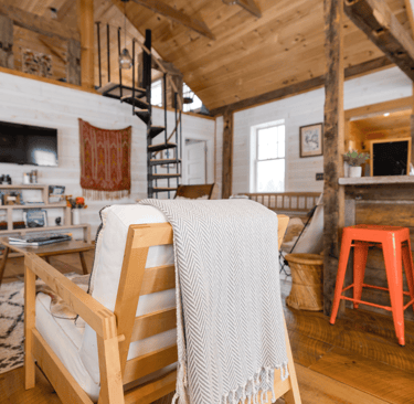 a living room with a couch and a bar stool