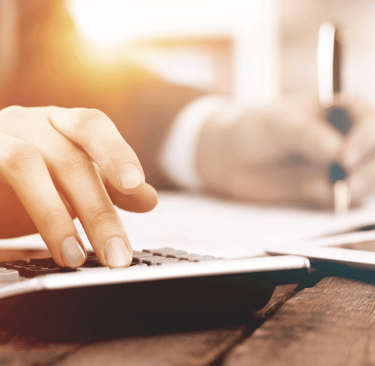 a person using a calculator on a laptop