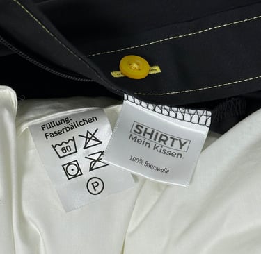 care label of a shirt and pillow