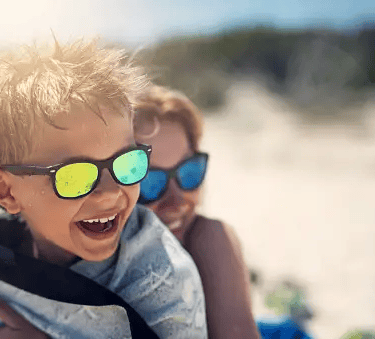 two boys wearing sunglasses and sunglasses on a beach