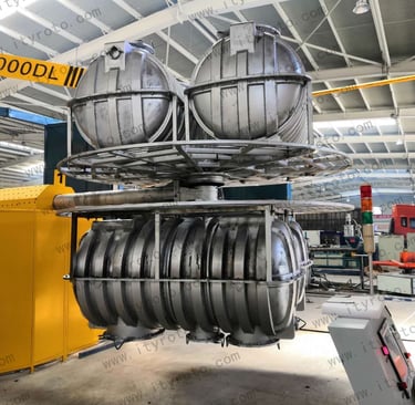 Rotational molding machine and control area for plastic tank manufacturing.