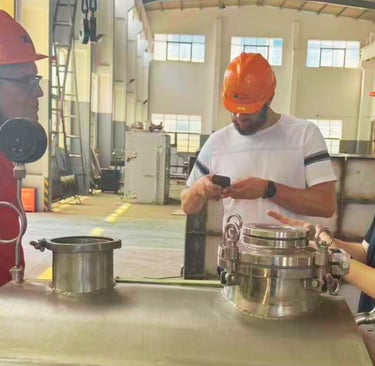 A foreign client conducting an onsite audit and factory tour at a paddle dryer manufacturing plant