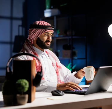 side-view-muslim-guy-holding-cup-coffee-surfing-net-his-digital-laptop-image-showcasing-male-arab-person-engrossed-his-person