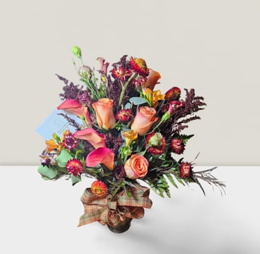 a bouquet of flowers in a vase on a table