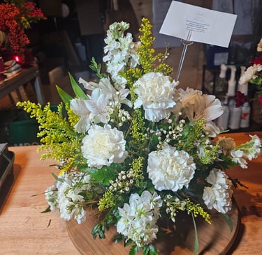 a vase with flowers on a wooden table