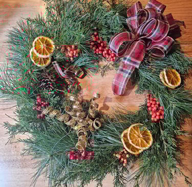 a wreath made of pine cones and oranges