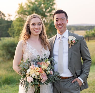 a man and woman standing in a field