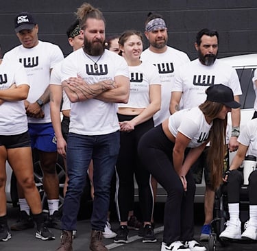 Group of individuals wearing white Winter Warrior t-shirts