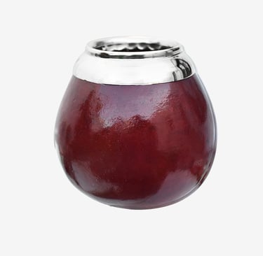 Polished dark red yerba mate gourd cup with a silver metal rim on a white background.