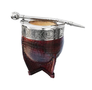 Handcrafted leather-wrapped yerba mate gourd with silver rim and bombilla straw.