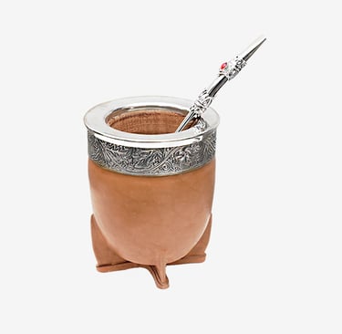 Traditional Argentine leather yerba mate gourd with ornate silver rim and bombilla straw.