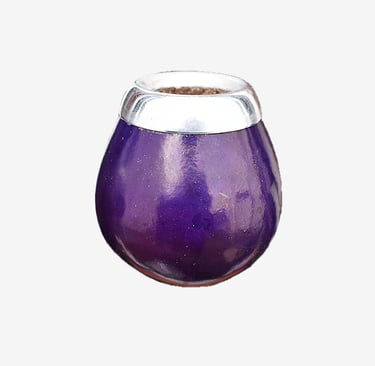 Polished purple gourd mate cup with a decorative silver metal rim for yerba mate tea.