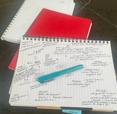 a pie of notebooks and handwritten notes