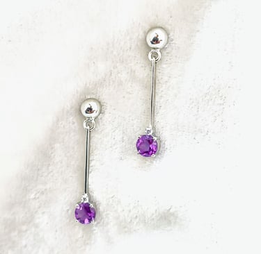 a pair of earrings with Amethyst