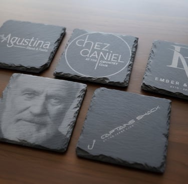 Various restaurant logos and a face in slate rock engaved