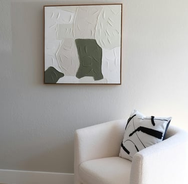 Minimal cozy living room with neutral wall art, and a soft sofa